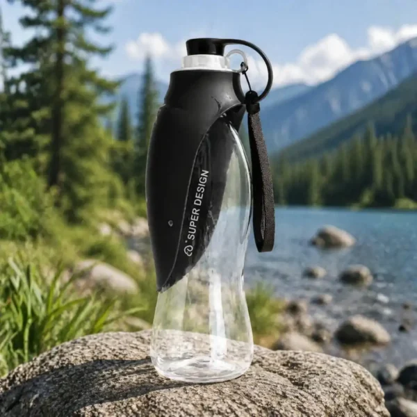 Foldable pet water bottle for travel with integrated drinking cup tray shown extended for a dog